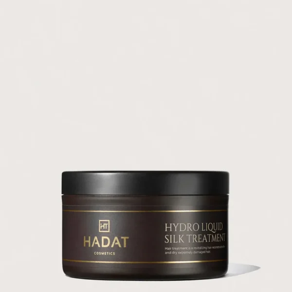 Dark brown Hadat cosmetics jar labeled Hydro Liquid Silk Treatment with black lid, gold branding on a light background, product for hair repair.