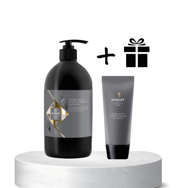 Two Hadat haircare products (shampoo bottle and tube) displayed on a white pedestal with a gift icon indicating a gift offer or bundle.