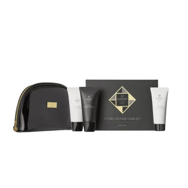 Hair treatment set with black box and white tubes arranged on a glossy black bag, gold accents and branding visible (Hydro Repair Hair Set)