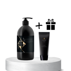 Two dark cosmetic containers (pump bottle and tube) sit on a white pedestal, with a gift icon to the right suggesting a free gift.