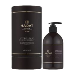 Dark brown Hadat cosmetics Hydro Liquid Silk Treatment bottle with matching cylindrical box and gold trim; pump bottle and label visible (500 ml).
