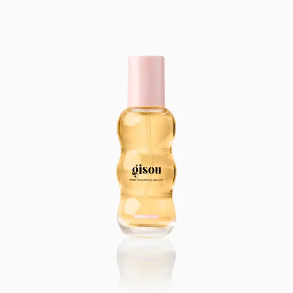 Gisou honey-infused hair perfume bottle with a pink cap, golden amber liquid visible through a wavy glass bottle, front label readable: 'gisou'.