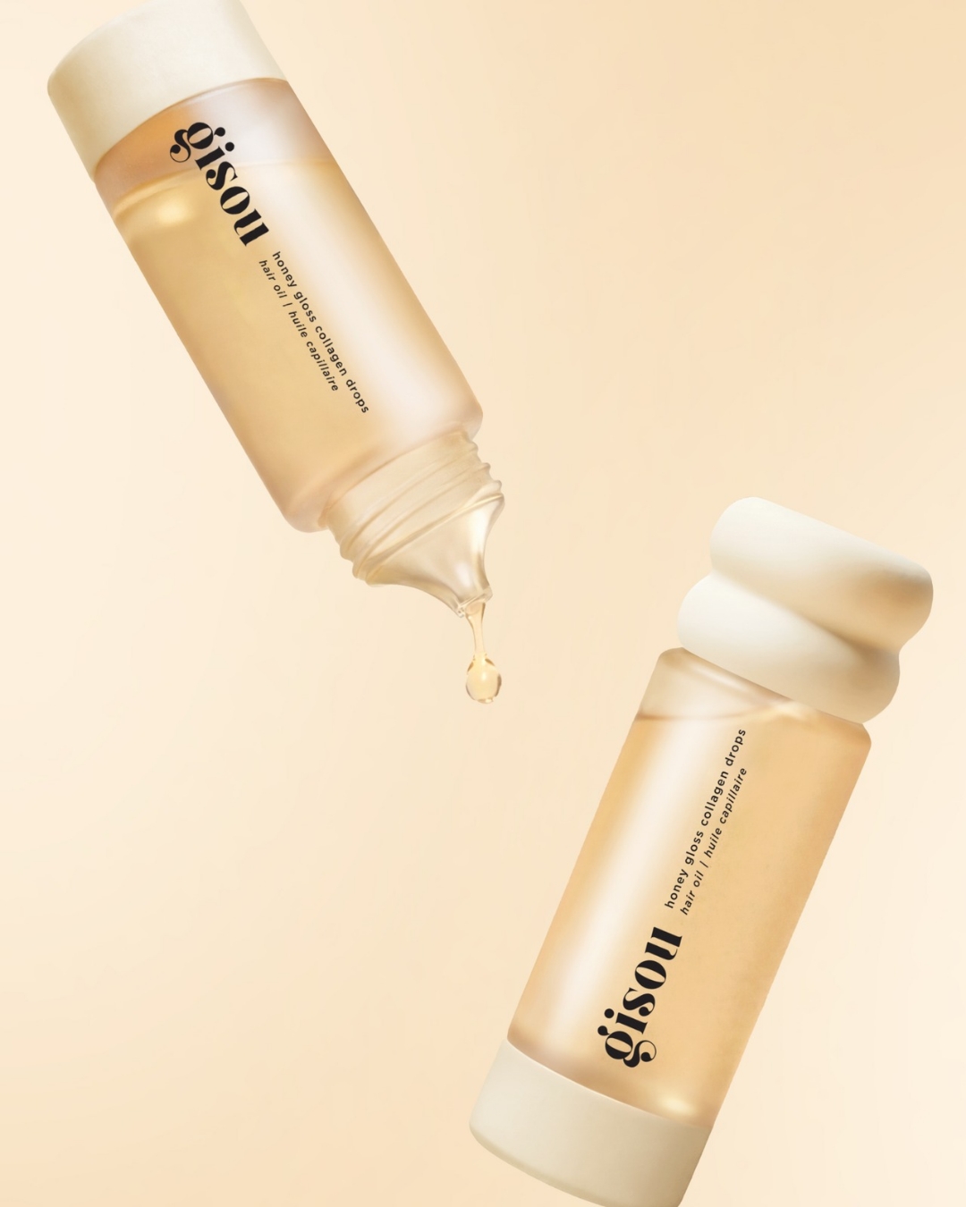 Two beige cosmetic bottles with white caps containing golden serum, labeled 'gisoul honey gloss collagen drops' (cosmetic skincare product).