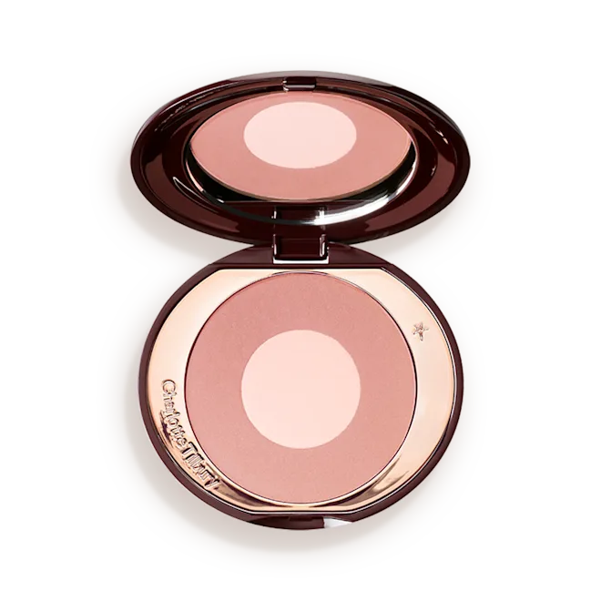 CHEEK-TO-CHIC-PILLOW-TALK-PACKSHOTpng - shopcosmoprof.com Open compact containing pink-toned face powder with a pale center, mirror reflecting above it