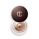 Charlotte Tilbury round makeup compact with bronze cream eyeshadow and gold CT logo on the lid.