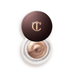 Charlotte Tilbury round makeup compact with bronze cream eyeshadow and gold CT logo on the lid.