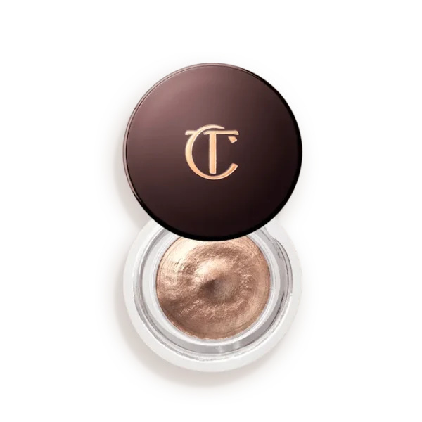 Charlotte Tilbury round makeup compact with bronze cream eyeshadow and gold CT logo on the lid.