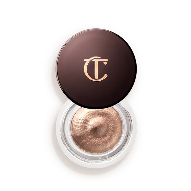 Champagne-Lid-Off-Packshotpng - shopcosmoprof.com Charlotte Tilbury round makeup compact with bronze cream eyeshadow and gold CT logo on the lid.