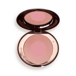 Open round makeup compact with pink pressed powder blush and mirror reflection inside.