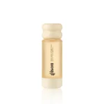 Small amber bottle of hair oil with a cream wavy cap, labeled collagen drops on a white background