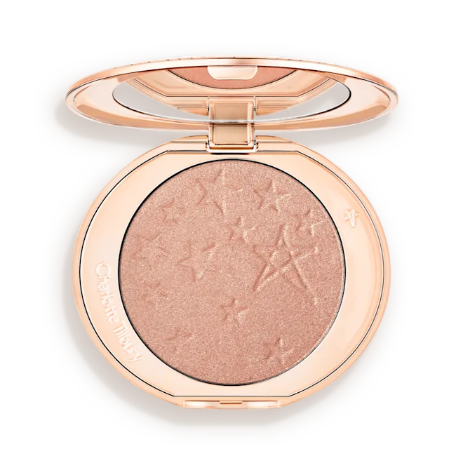 Hollywood-Highlighter-Pillowtalk-Glow-Packshotspng - shopcosmoprof.com Round rose-gold makeup compact opened to reveal a shimmery peach highlighter with star embossing on the powder surface.