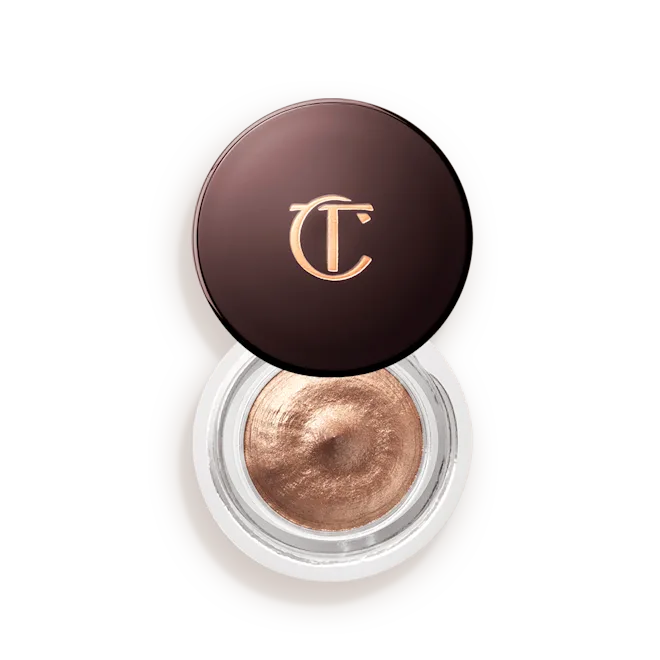 Oyster-Pearl-Lid-Off-Packshotpng - shopcosmoprof.com Bronze-cream eyeshadow in an open circular jar with a dark brown lid bearing a gold CT/CT logo, showing metallic product inside.