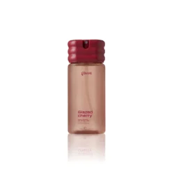 Gisou Glazed Cherry hair and body mist bottle with pink cap and rose-gold body.