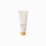 Cream cosmetic tube with orange cap, standing upright, beige packaging and gold text logo visible on the side (No. 5-1-? styling cream)