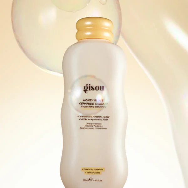 Gisou Honey Gloss Ceramide Therapy Hydrating Shampoo bottle with peach cap on a light background (product image)