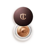 Copper metallic eye shadow in a round pot with a dark brown lid featuring a gold 'TC' logo.