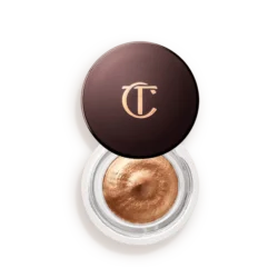 Copper metallic eye shadow in a round pot with a dark brown lid featuring a gold 'TC' logo.