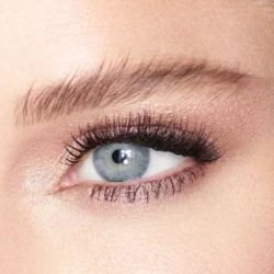 jean-modeljpg - shopcosmoprof.com Close-up of a blue eye with thick mascara, dark eyeliner, and a well-groomed eyebrow above it.