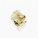 Cream-colored, shell-shaped ring with a small gold 'B' centerpiece.