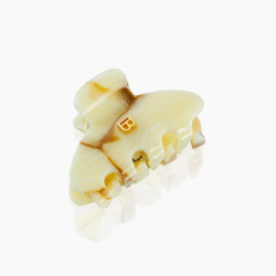 Marbled beige-yellow hair clip with interlocking teeth and a small gold 'B' logo