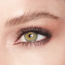 maroe-antoinette-modeljpg - shopcosmoprof.com Close-up of a green hazel eye with pink shimmery eyeshadow, black eyeliner, and long lashes, with a groomed eyebrow above.