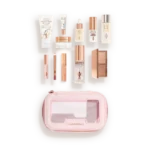 Charlotte Tilbury travel makeup kit opened to reveal mini skincare and cosmetics in a pink zippered case.