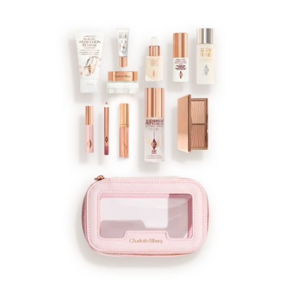 Charlotte Tilbury travel makeup kit opened to reveal mini skincare and cosmetics in a pink zippered case.