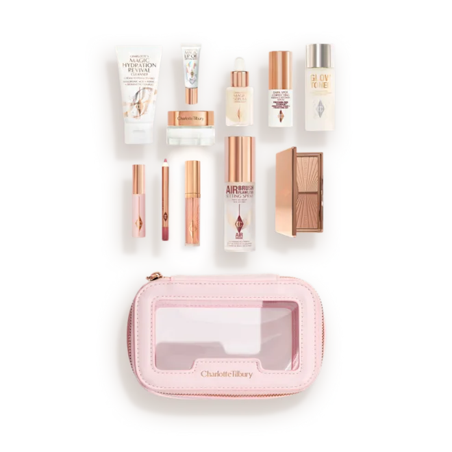 pdp-travel-minis-bag-bag-and-prods2png - shopcosmoprof.com Charlotte Tilbury travel makeup kit opened to reveal mini skincare and cosmetics in a pink zippered case.