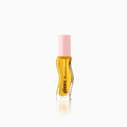 Bottle of perfume oil with a pink cap and curved amber body on a white background, side view.