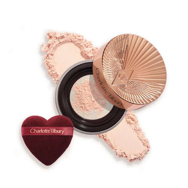 OPEN-PACKSHOT-BRIGHTENING-PEACH-SWATCH__1_png - shopcosmoprof.com Charlotte Tilbury powder compact with pink powder and a heart-shaped burgundy applicator sponge.