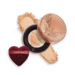 Charlotte Tilbury pressed powder compact with crushed powder and a heart-shaped applicator sponge