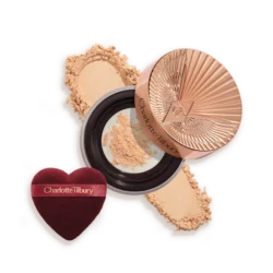 Charlotte Tilbury pressed powder compact with crushed powder and a heart-shaped applicator sponge