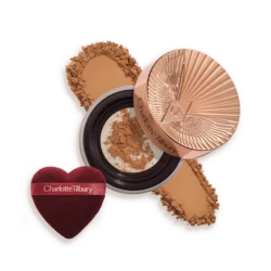 Charlotte Tilbury compact powder with rose-gold lid, pressed powder, and heart-shaped applicator puff
