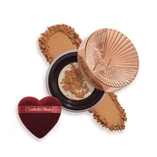 Charlotte Tilbury compact powder with rose-gold lid, pressed powder, and heart-shaped applicator puff