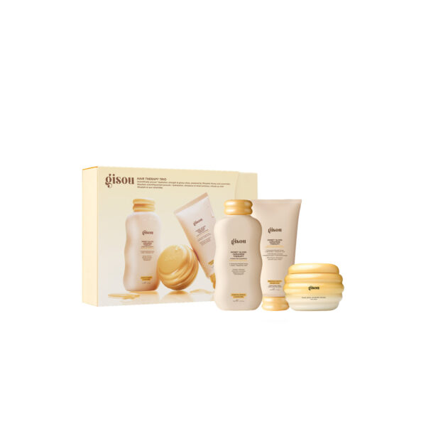 Gisou hair care gift set showing boxed products and several beige-gold bottles and jars arranged together