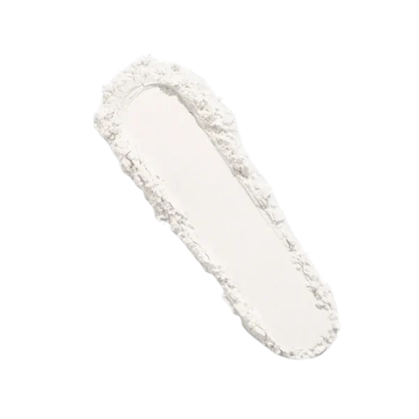 Flat, spoon-shaped spatula with a white powder along its edge and center.
