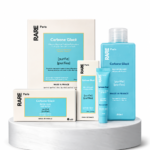 Set of RARE Paris skincare products in blue and white packaging on a white marble pedestal (Carbone Glacé line).