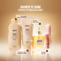 02_3b6351f8-ccd9-4327-9a4c-200c799e78db - shopcosmoprof.com Brand-name hair care lineup with Gisou products and labels: Honey Gloss, Mini Shampoo, Hair Oil, Lip Oil, in warm gold background. Image highlights 'Shower to Shine' campaign.