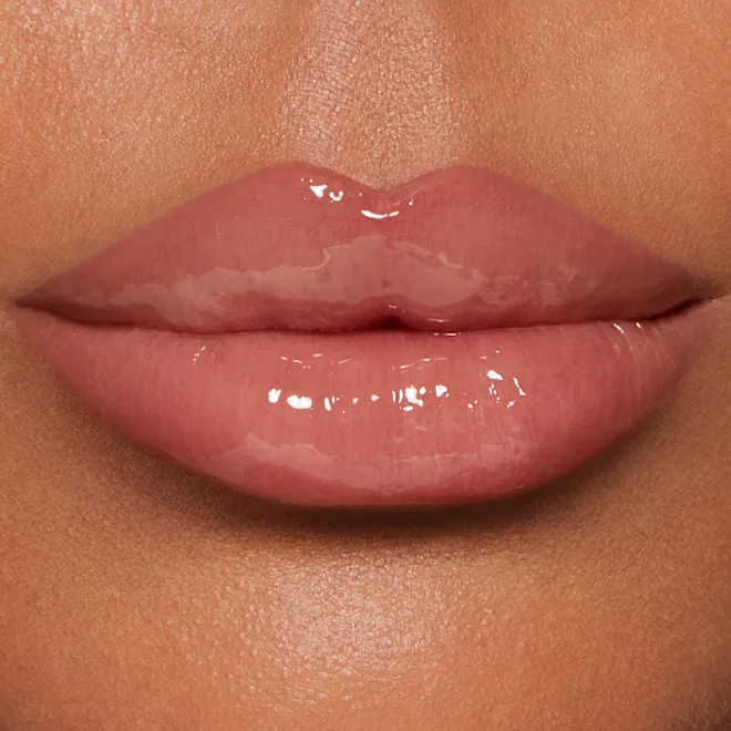 Close-up of glossy pink lips with a shiny, smooth finish.