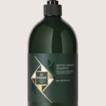 Dark green Detox Therapy Shampoo bottle with black pump, Hadat Cosmetics label and gold geometric design (800 ml).