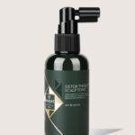 Dark green spray bottle labeled Detox Therapy Scalp Tonic with black spray nozzle.