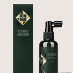 Dark green bottle with black spray top beside a matching dark green box, labeled Detox Therapy Scalp Tonic by HADAT cosmetics, 60 ml.