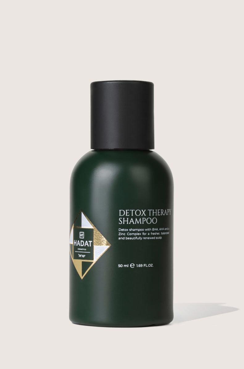 112544_DETOX THERAPY SHAMPOO 50 ml - shopcosmoprof.com Dark green shampoo bottle with a black cap and a Hadat Cosmetics logo on the label; reads Detox Therapy Shampoo (50 ml).