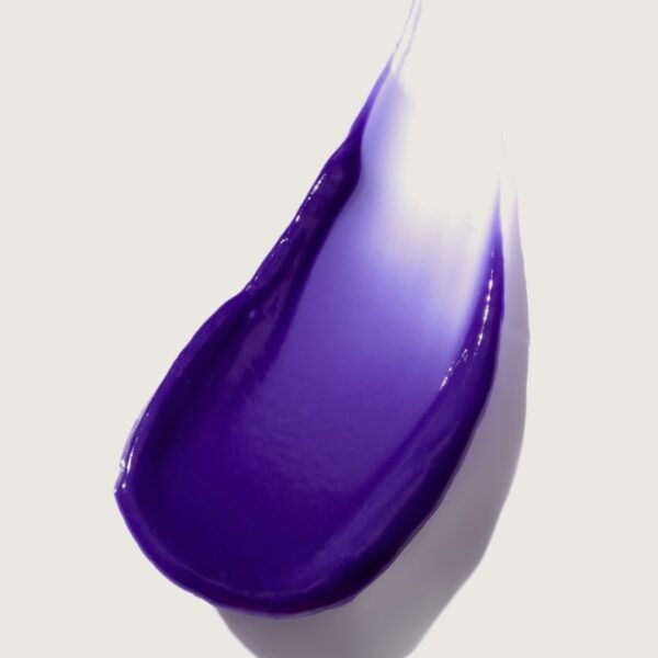 Bold purple paint stroke on a light background, abstract art.