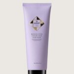 Lavender HADAT Blonde Code Color Lock Hair Mask tube with black cap on beige background, product shot for color protection.
