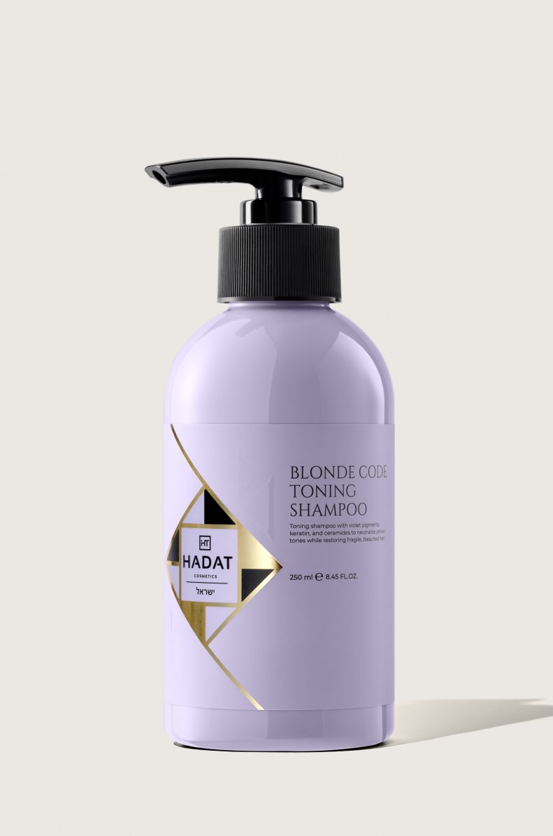 112558_BLONDE CODE TONING SHAMPOO 250 ml - shopcosmoprof.com Lavender-colored bottle with a black pump labeled Blonde Code Toning Shampoo by Hadat Cosmetics on a light background.