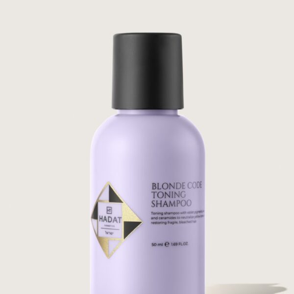Lilac bottle of Blonde Code Toning Shampoo with black cap and Hadat Cosmetics logo.
