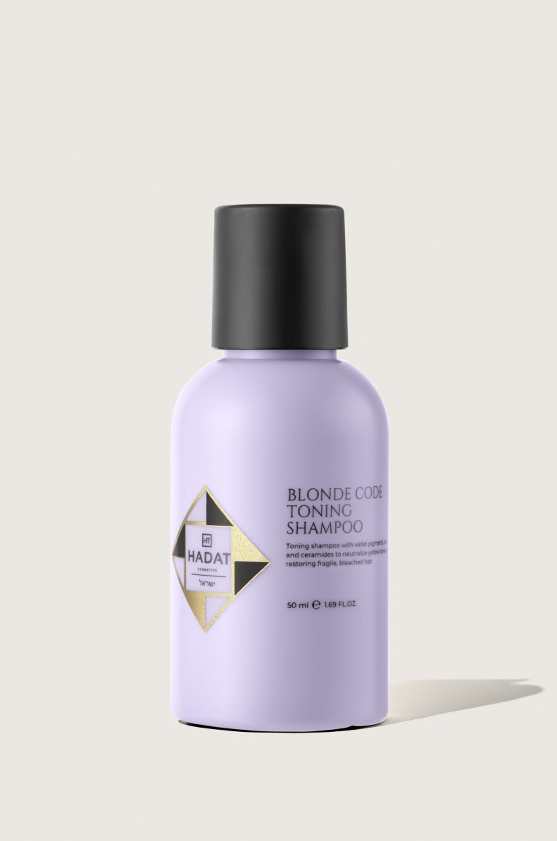 112559_BLONDE CODE TONING SHAMPOO 50 ml - shopcosmoprof.com Lilac bottle of Blonde Code Toning Shampoo with black cap and Hadat Cosmetics logo.