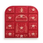 Red Charlotte Tilbury advent calendar with 12 numbered door compartments and star decorations, all closed.