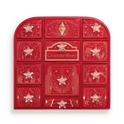 Red Charlotte Tilbury advent calendar with 12 numbered door compartments and star decorations, all closed.